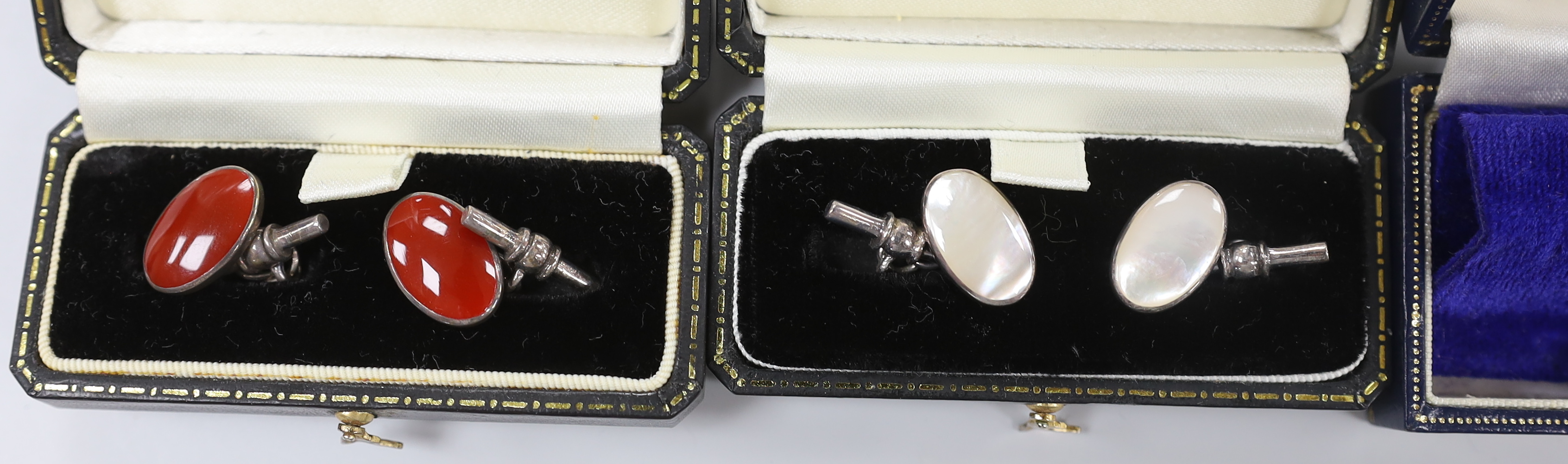 Four pairs of modern cufflinks including 925 and blue guilloche enamel and 925 and carnelian and two other white metal, set with tiger's eye quartz or mother of pearl.